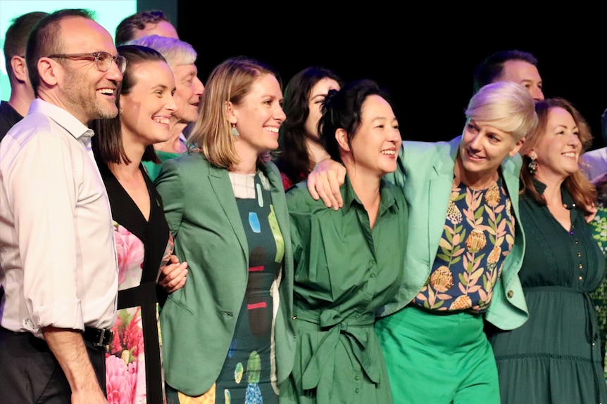 Group of men and women smiling and hugging