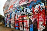 Swastika spray painted on rock wall