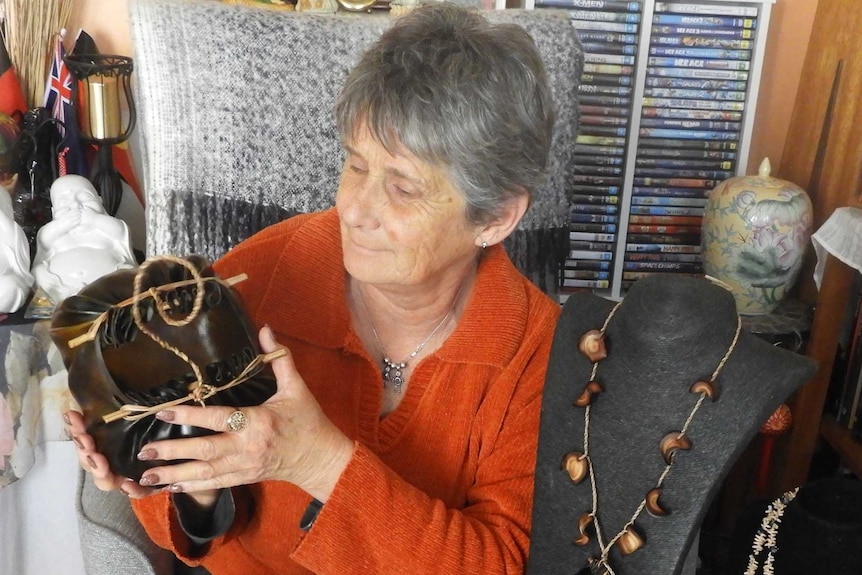 Tasmanian Aboriginal elder Netty Shaw holds up a traditional kelp basket.