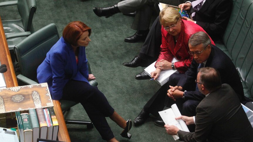 Julia Gillard speaks to Jenny Macklin, Wayne Swan and Anthony Albanese during question time.