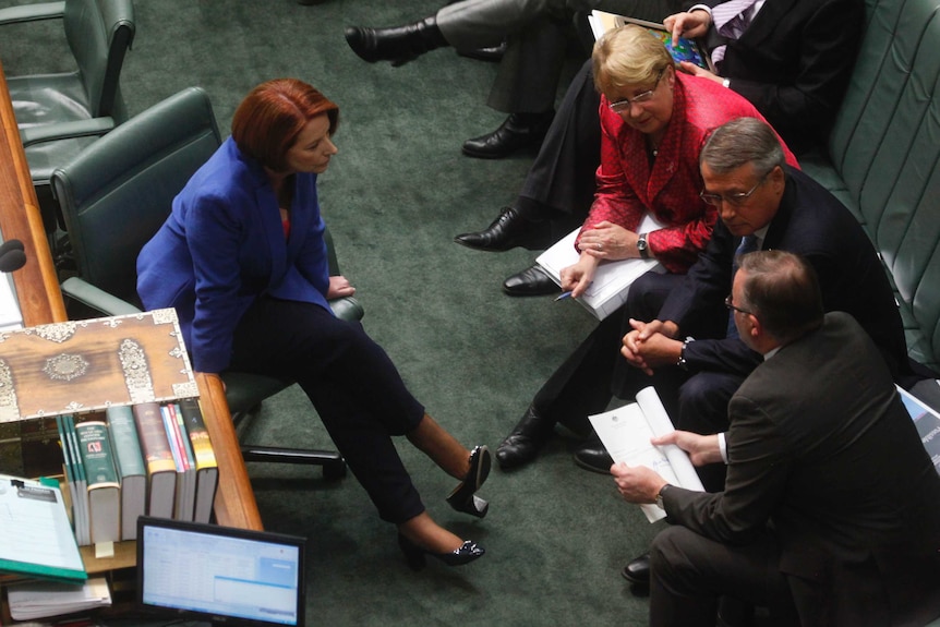 Julia Gillard speaks to Jenny Macklin, Wayne Swan and Anthony Albanese during question time.