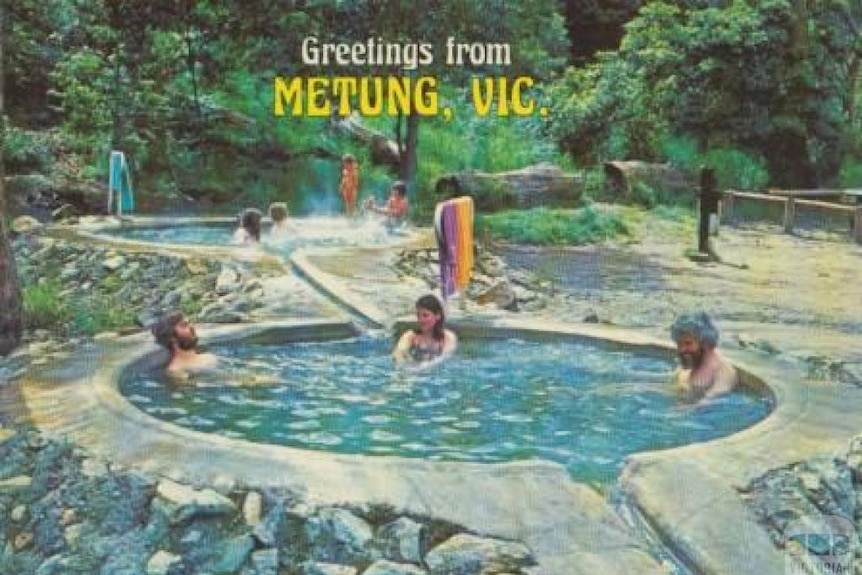 Old post card of people sitting in a hot pool