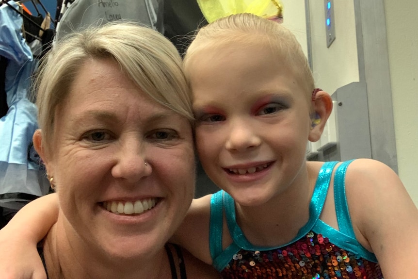 A mother and daughter take a close up selfie. 