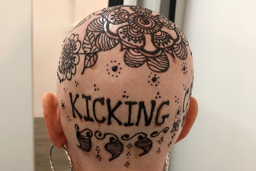 Henna crown, on a woman's bald head, including the words 'kicking cancer'.