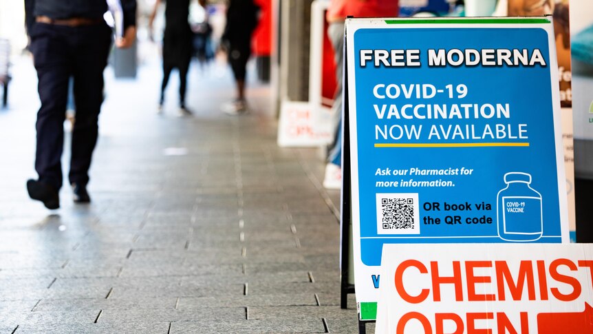 A sign outside a pharmacy reading 'Free Moderna COVID-19 Vaccination Available'.