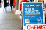 A sign outside a pharmacy reading 'Free Moderna COVID-19 Vaccination Available'.