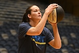 Alicia Froling holds the basketball in both hands, preparing to shoot