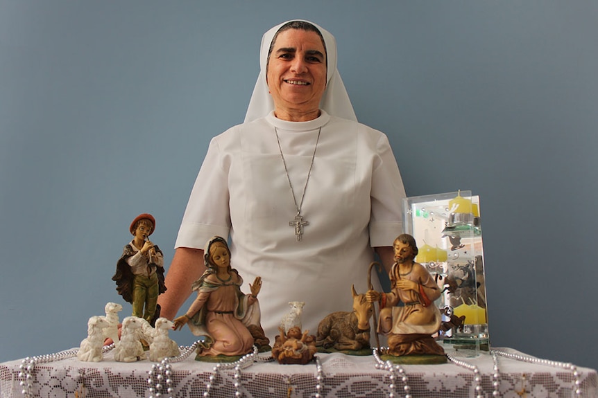 Sister Pauline Bonavia standing with one of the cribs displayed at Francis of Assisi home in Mackay.