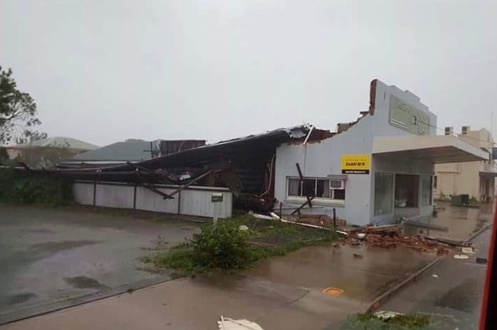 A Proserpine shopfront is damaged after Cyclone Debbie.