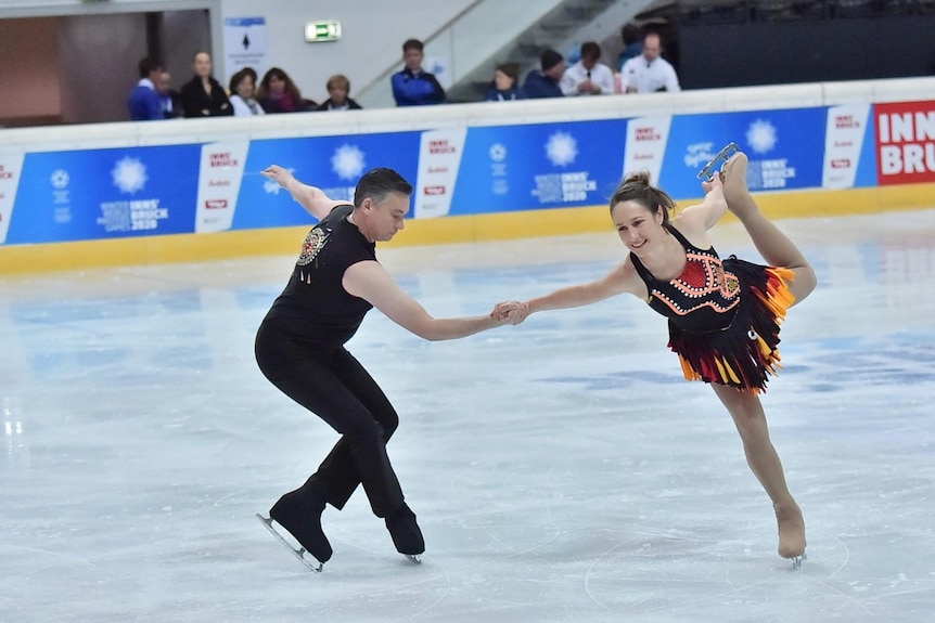 Robbie Bayliss and Julie Kernich-Curugliano holding a figure skating move.