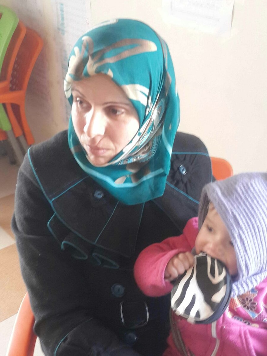 Feydan, who teaches sewing to a group of women in Syria