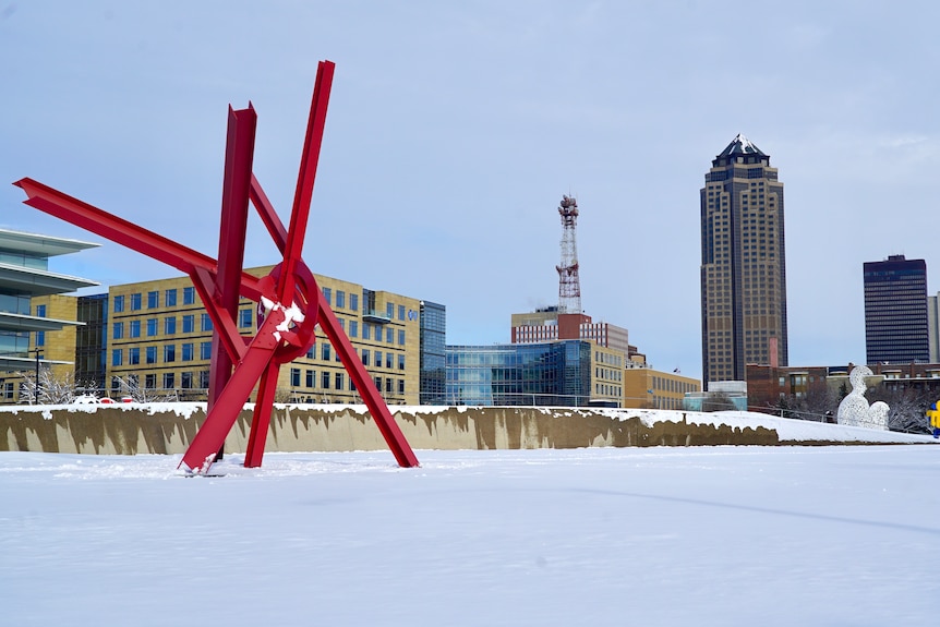 The Des Moines skyline with a large red sculpture comprised of multiple rods in the foreground.