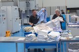 Workers fold laundry in Toowoomba