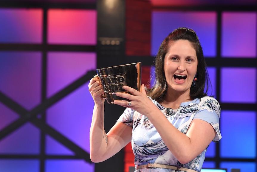 Mary Bolling holds up a hard quiz trophy