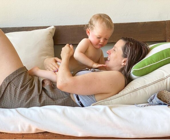 Alexandra Collier with her baby son on the couch