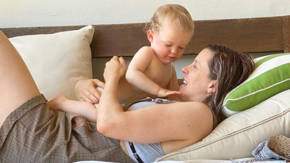 Alexandra Collier with her baby son on the couch