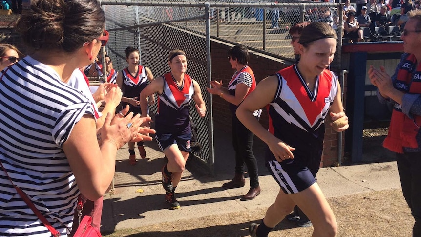 Darebin Falcons run onto the oval for the 2014 VWFL Grand final.