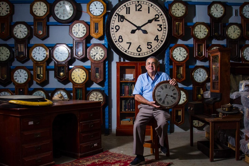 Clock repairer Doug Minty at the Sydney Central Station mechanical clock collection.