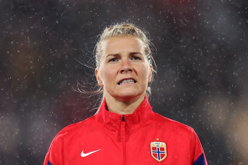 Norway football player Ada Hegerberg stands in the rain before a FIFA Women's World Cup match.