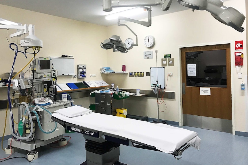 An empty operating theatre with bright lights on.