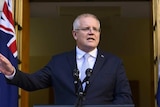 Scott Morrison speaks from a lectern with his hand outstretched