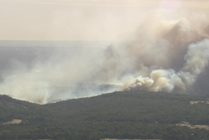A large amount of smoke stemming from a bushfire. 