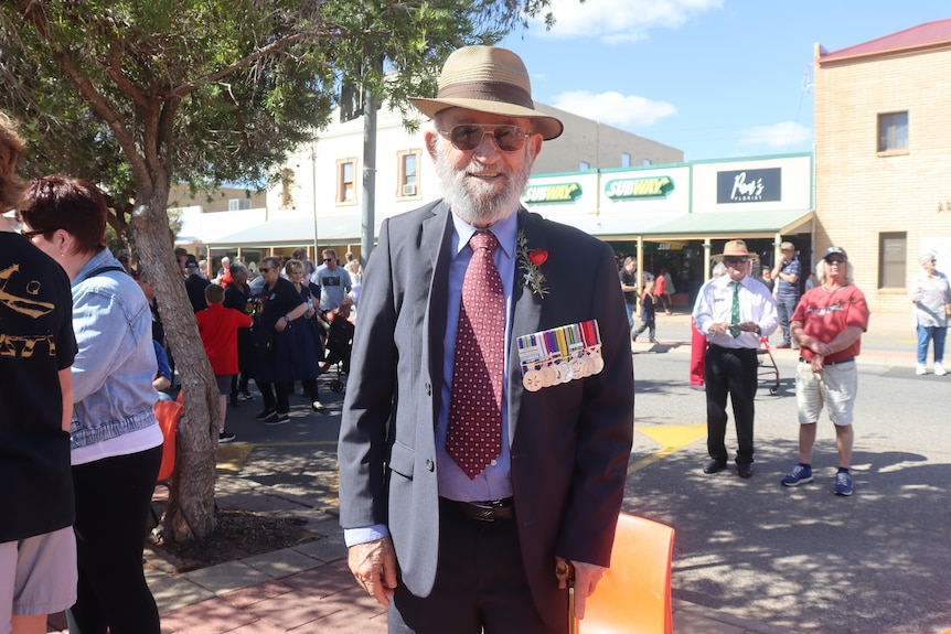 old man in a hat with chest full of medals