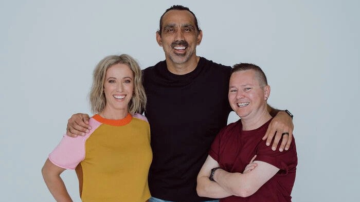 Somebody's Land illustrator David Hardy poses alongside authors Adam Goodes and Ellie Laing.