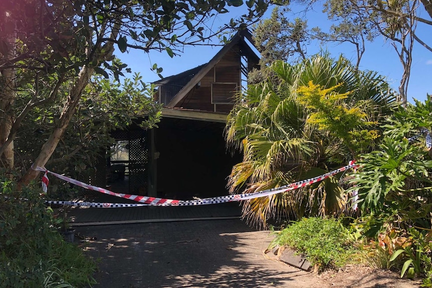 Fire damaged house at Peregian Beach with police tape in front.