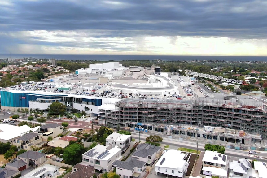 drone picture of Karrinyup shopping centre with new apartment construction in the foreground and bush and ocean in the backgrou