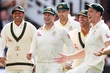 Australian players celebrate with Mitchell Starc after a wicket