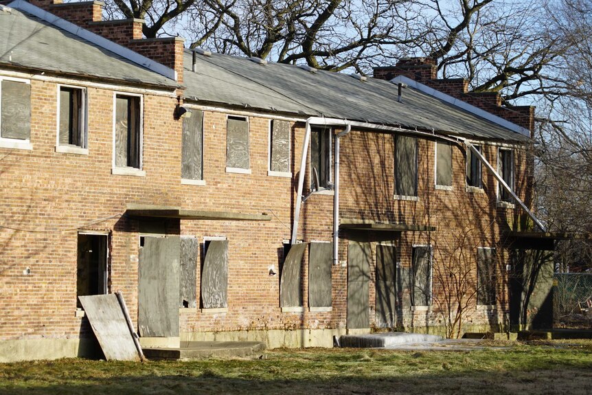 Old units with boarded up windows and doors
