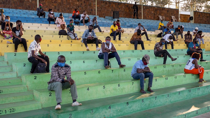 People who did not respect the measures to prevent the spread of the COVID-19 (novel coronavirus) pandemic, such as the correct wearing of masks in public places, are forced to sit and listen the prevention speeches for a few hours in Nyamirambo stadium in Kigali, Rwanda on August 3, 2020.