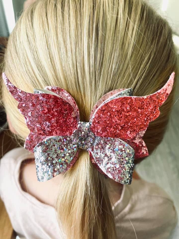 a large pink, glittery hair bow