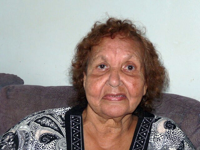indigenous shell artist esme timbery sits on a lounge while looking at the camera