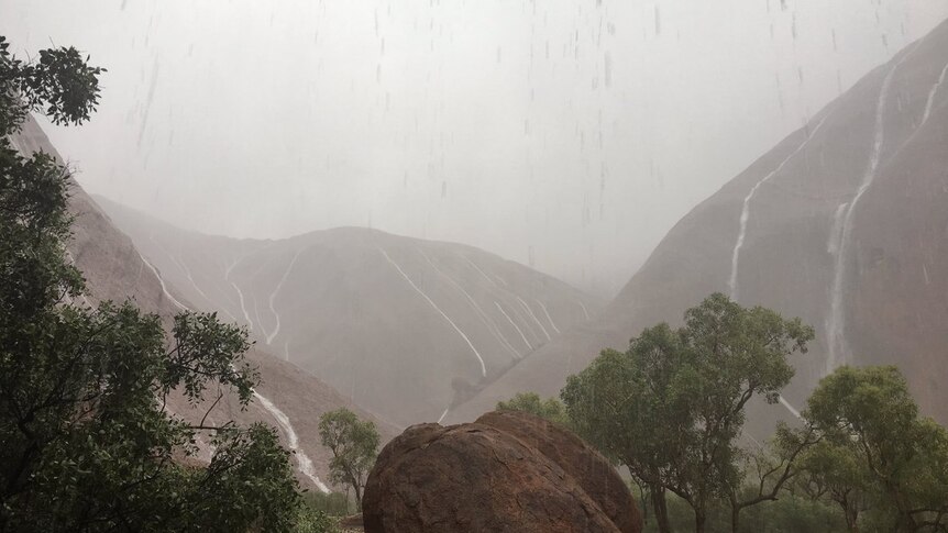 Uluru is drenched in heavy rain
