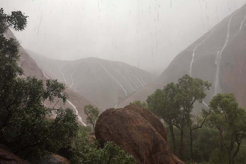 Uluru is drenched in heavy rain