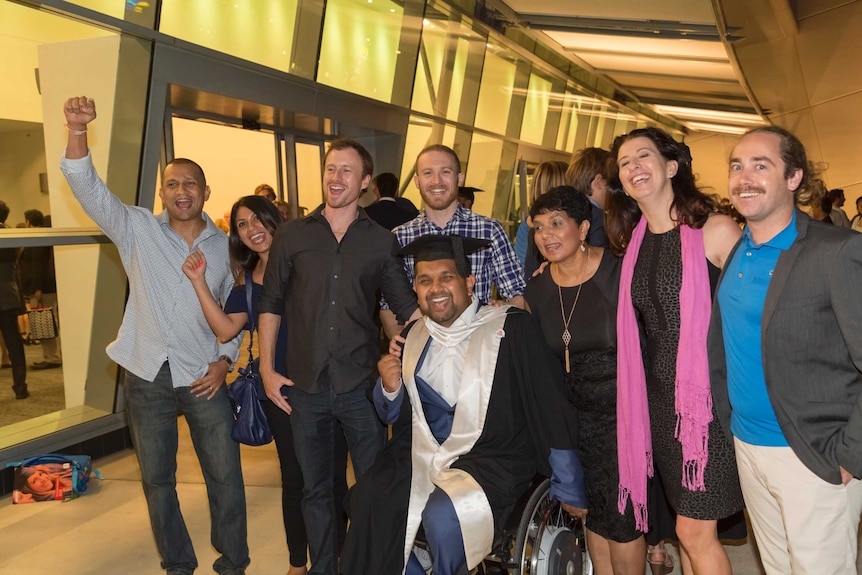 Dinesh with his mother, extended family and friends after graduating