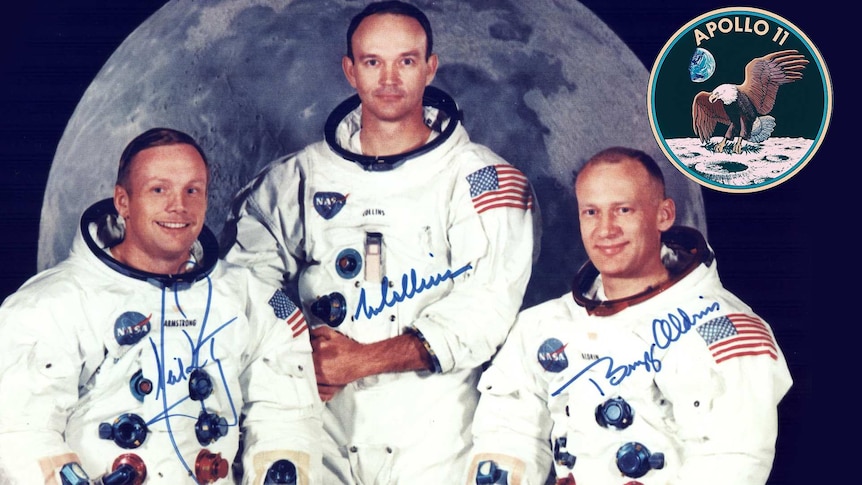 A group photo of three astronauts from 1969 with the Moon as a backdrop and Apollo 11 insignia in the corner.