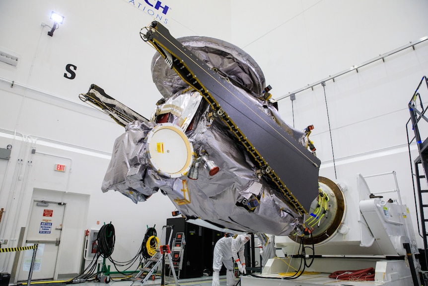 NASA's Lucy spacecraft is moved to the horizontal position on a rotation stand.