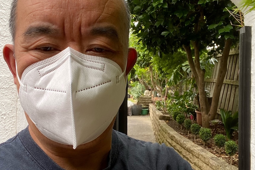 A man wearing a mask covering his nose and mouth.