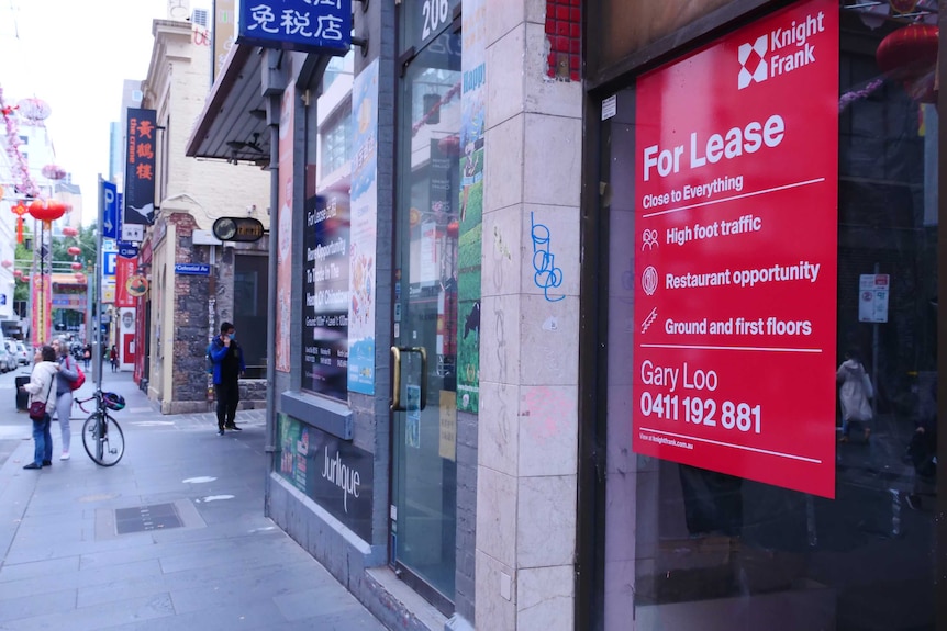 A big red 'for lease' sign displayed on a shopfront in Chinatown, the next shop also has a for lease sign