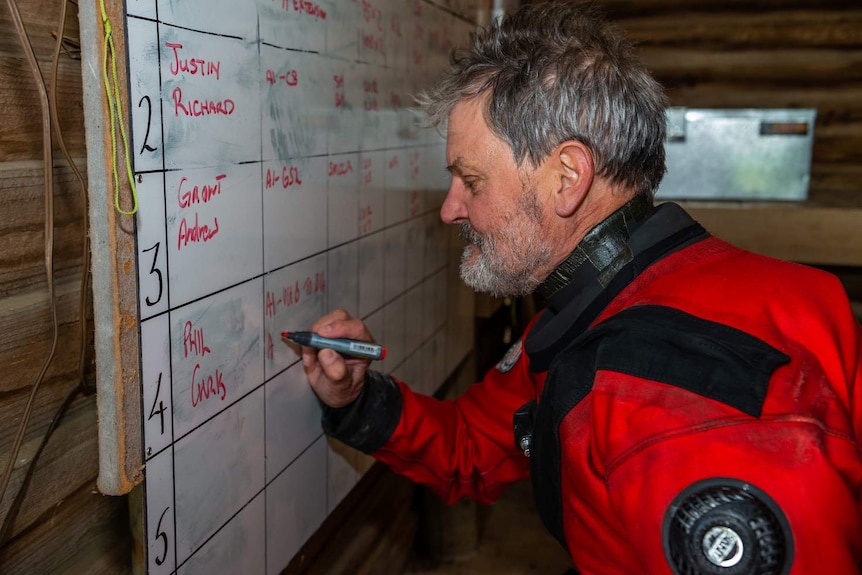 A diver marks a whiteboard.