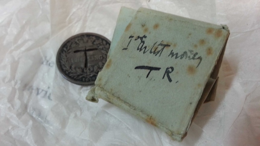 A valuable coin and handwritten note owned by the artist Tom Roberts.