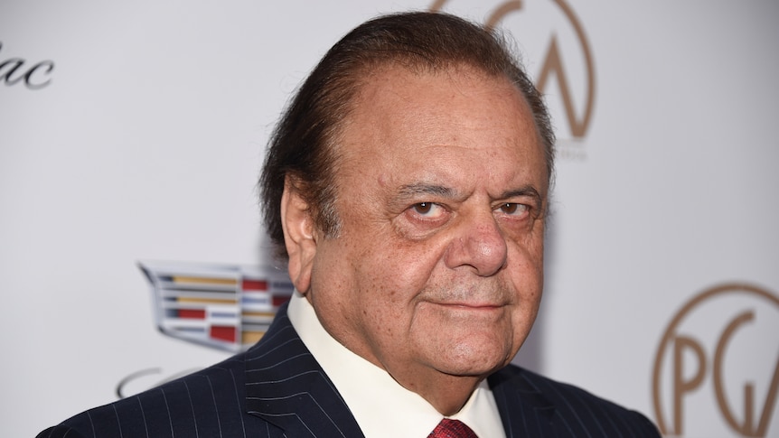 Paul Sorvino's face in front of a guild awards wall. 