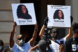 Protesters holding up signs of Breonna Taylor during a rally in her honour in Kentucky.