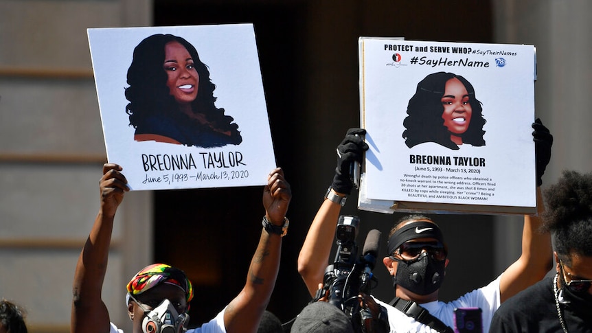 Protesters holding up signs of Breonna Taylor during a rally in her honour in Kentucky.