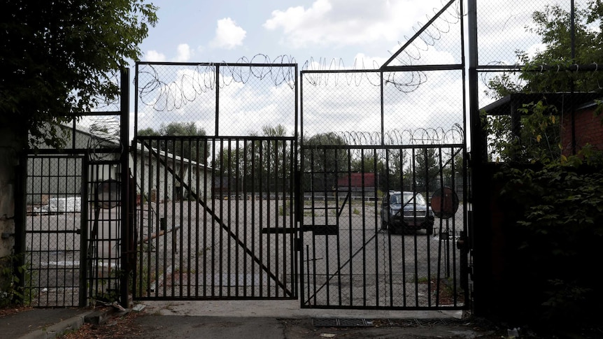 A US embassy car is seen through the gate at the entrance to the US embassy warehouse.