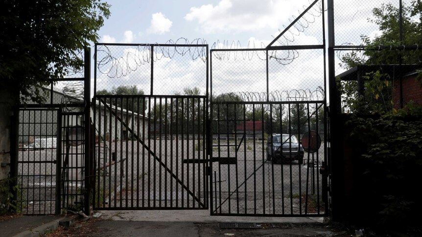 A US embassy car is seen through the gate at the entrance to the US embassy warehouse.