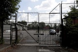 A US embassy car is seen through the gate at the entrance to the US embassy warehouse.